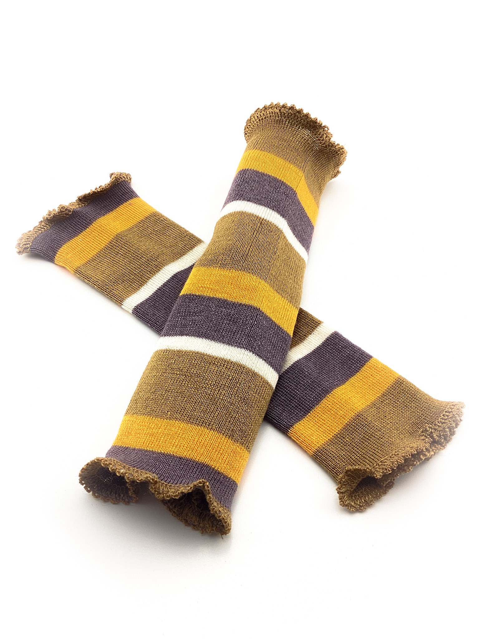 Gestreifte Armbänder aus Wolle in Gelb, Braun und Lila Zwei gestrickte Armbänder mit Streifenmuster in den Farben Gelb, Braun, Weiß und Lila auf weißem Hintergrund